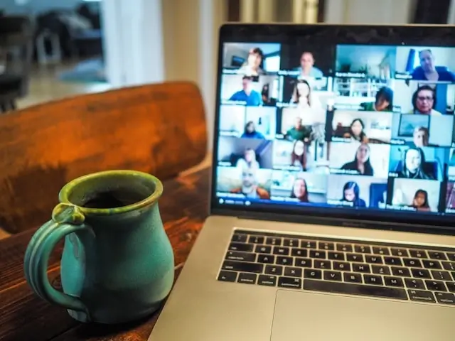 Virtual law class with multiple students on video conference call displayed on laptop screen, showcasing online legal education networking and collaborative remote learning