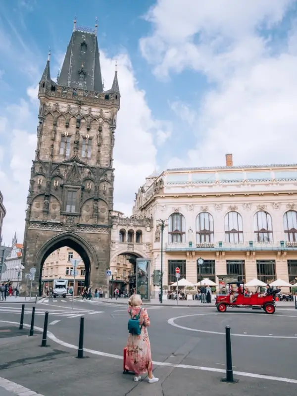 Tourist exploring historic European city tower and square during budget weekend getaway