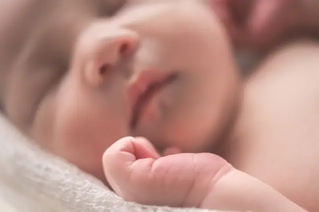 Peaceful sleeping newborn baby resting comfortably in safe sleep environment