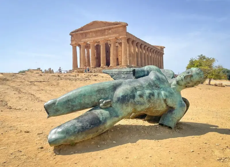 Ancient Greek Temple of Concordia with bronze statue at Valley of the Temples in Agrigento Sicily