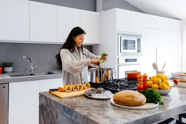 Woman preparing healthy meal with fresh vegetables in modern kitchen