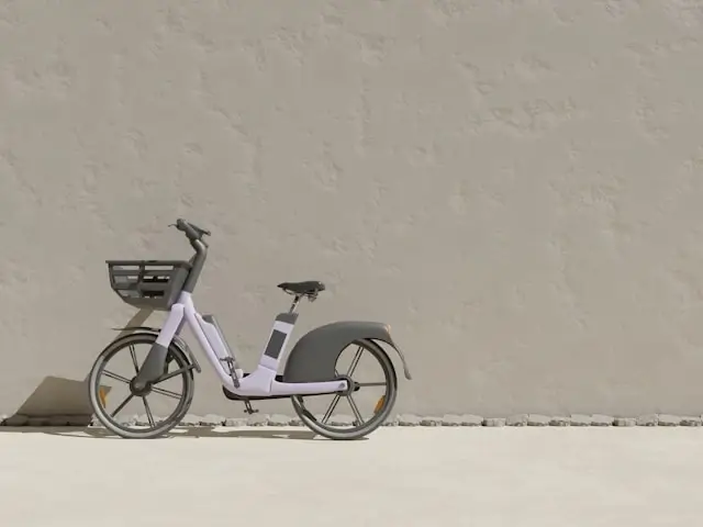 Modern white cargo e-bike with front and rear baskets parked against neutral wall