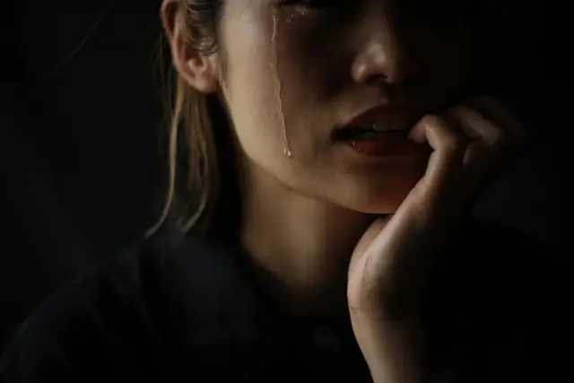 Emotional woman with tears showing trauma and pain after drunk driving accident