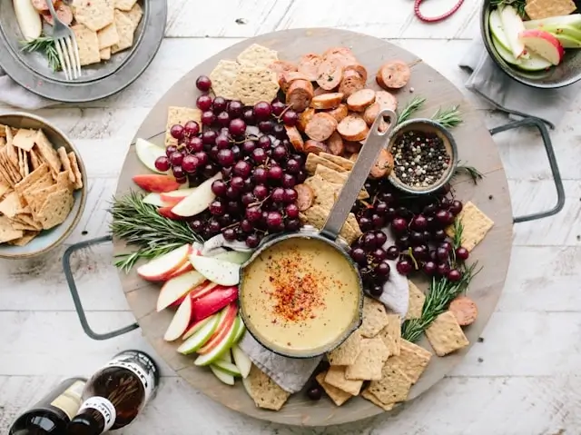 Healthy snack platter with fresh fruit, crackers, hummus, and grapes