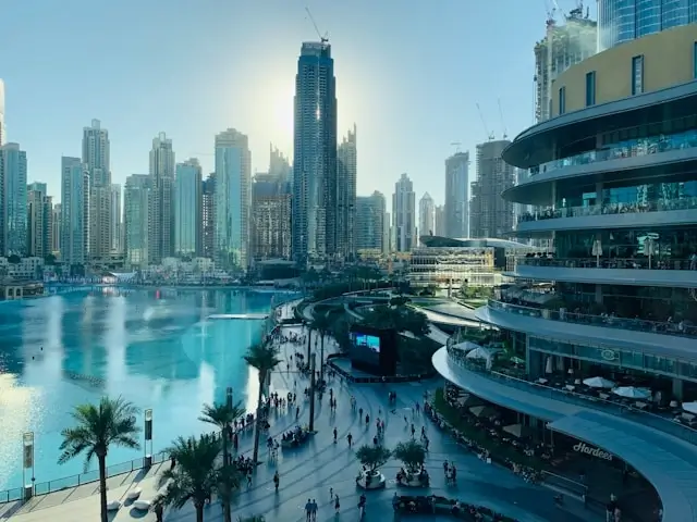 Hotels near Dubai Mall overlooking Burj Khalifa Lake and Downtown Dubai waterfront promenade during daytime