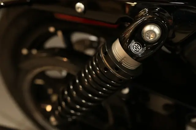 Close-up detail of chrome motorcycle rear shock absorber with black spring coils