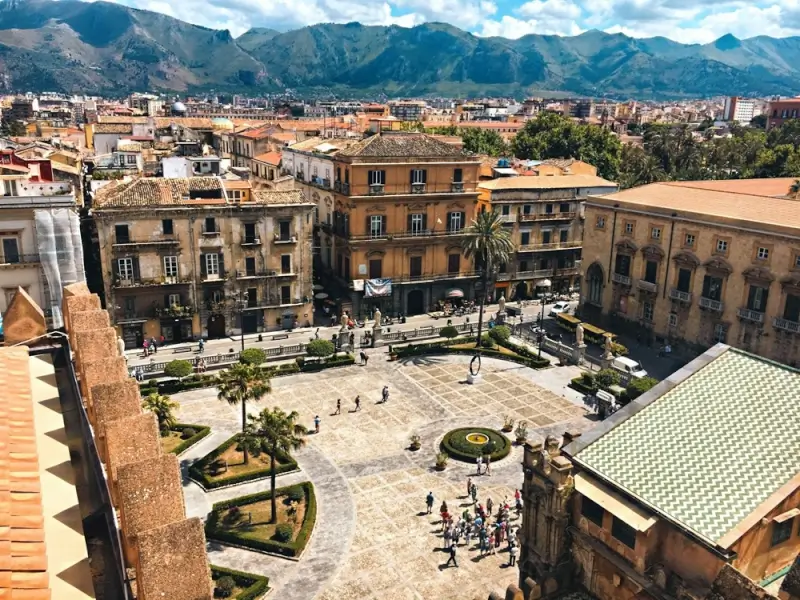 Panoramic view of Palermo main square with historic buildings and mountains in background Sicily