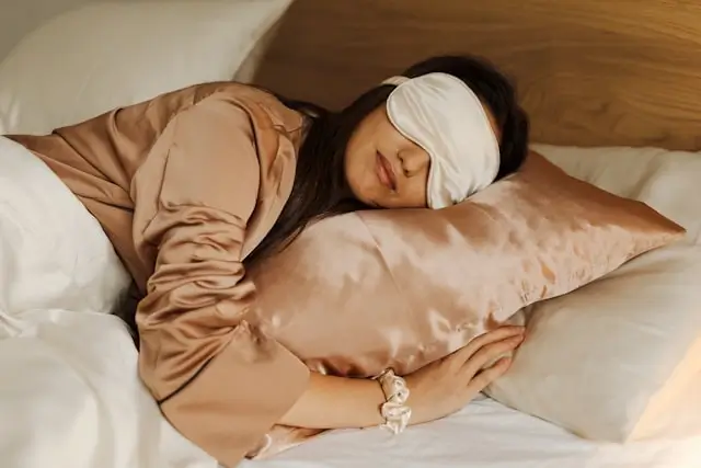 Quality sleep habits - woman resting peacefully with sleep mask for restful night