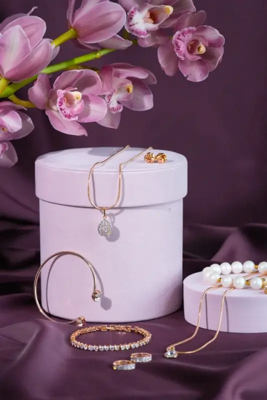 Elegant diamond and pearl jewelry displayed on a soft purple background with orchids, showcasing premium pieces often featured in online diamond shopping