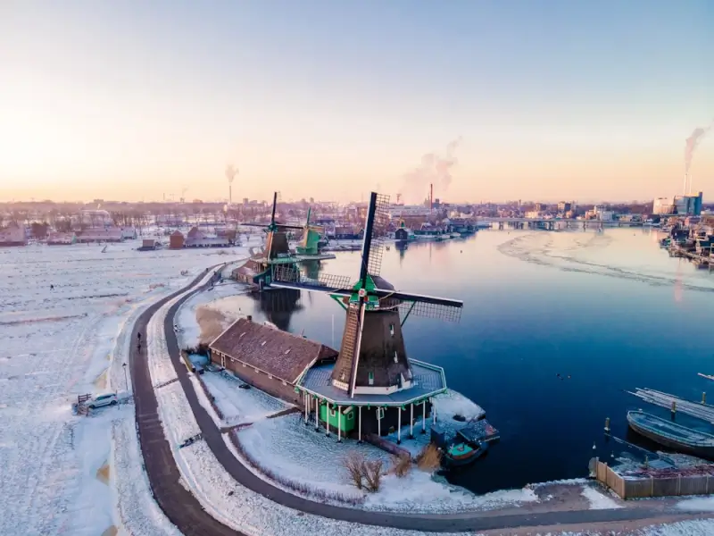 snow covered windmill in zaanse schans, a perfect destination for amsterdam day trip