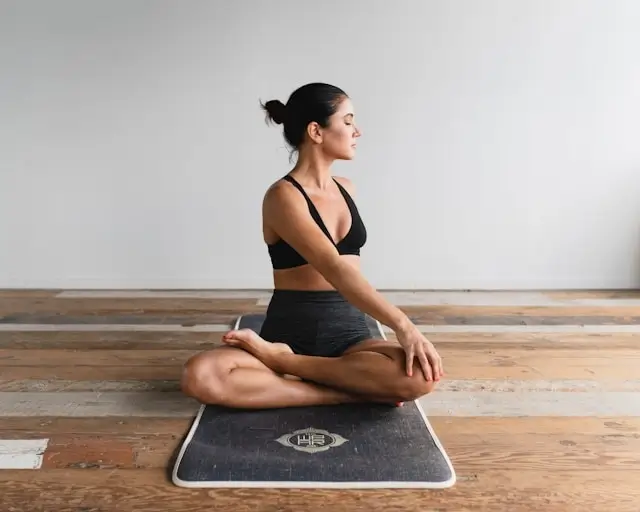 Stress management technique - woman meditating peacefully for mental and physical health