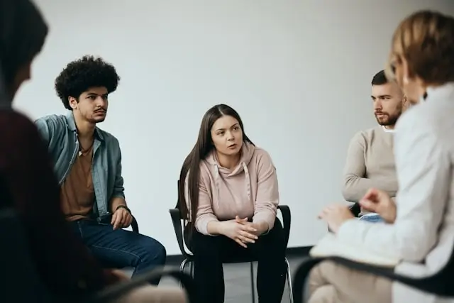 Support group meeting for drunk driving accident victims sharing experiences and recovery