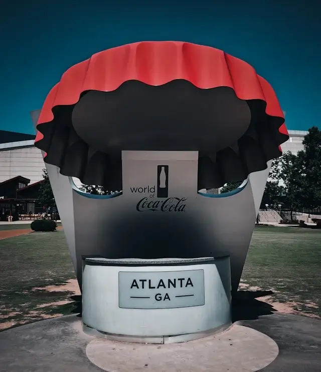 World of Coca-Cola Atlanta GA landmark sculpture with oversized Coke bottle cap display representing iconic cultural attraction for adults visiting Atlanta