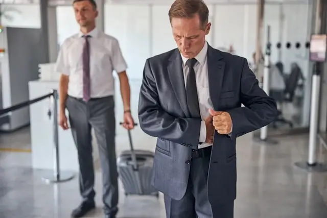 Business traveler checking documents while airport greeter provides personalized meet and greet assistance