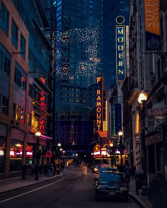 Boston Theater District at night with illuminated Paramount and Modern Theatre marquee signs and twinkling lights