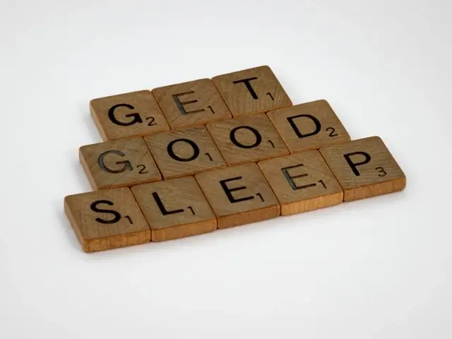 Scrabble tiles spelling out 'GET GOOD SLEEP' message emphasizing importance of quality rest during travel