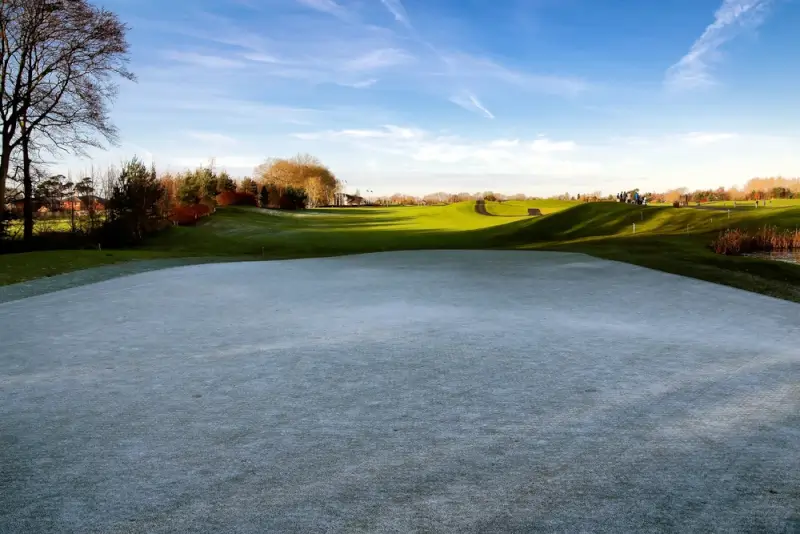 Frosty morning view of Dublin golf course with sand bunker and rolling green fairways