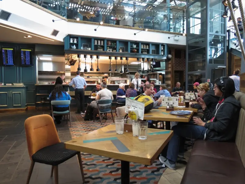 The Windmill Wetherspoons pub in Stansted departure lounge with travelers dining before flights
