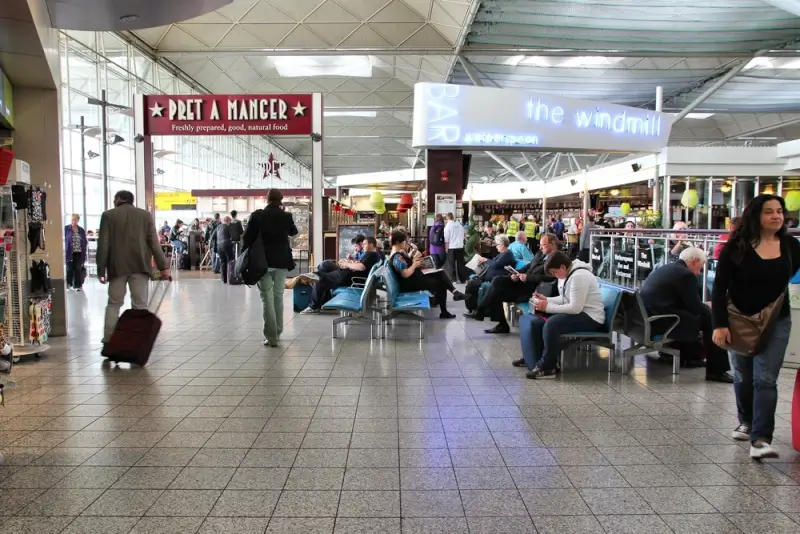 Airport terminal with Pret A Manger and The Windmill restaurant in departure lounge at London STN