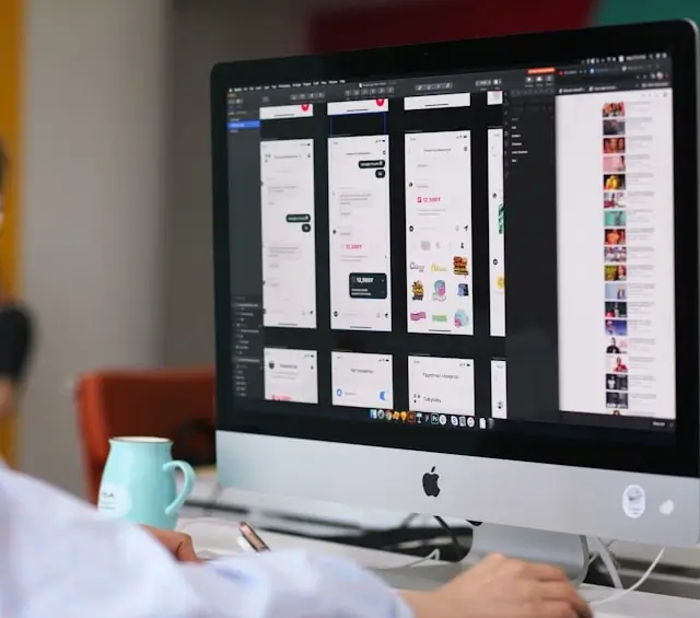 Designer reviewing multiple mobile app screens and illustrations in design tool interface