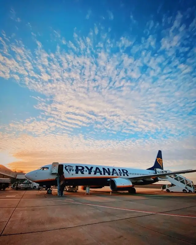 Ryanair aircraft on tarmac at Stansted Airport during sunset, largest base for low-cost European flights