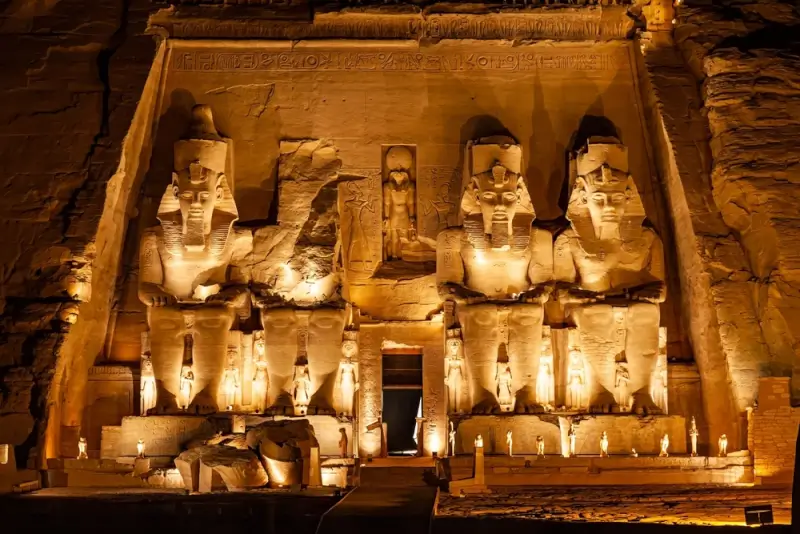 Colossal statues of Pharaoh Ramses II at Abu Simbel Great Temple illuminated at night, monumental backdrop for August 2027 total eclipse
