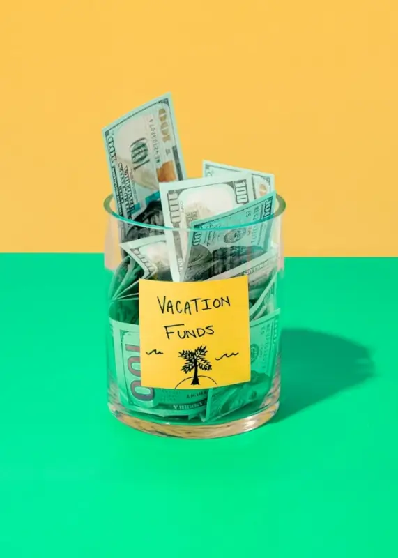 Vacation funds jar filled with cash for budgeting adventure trips abroad