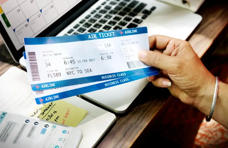 Money saving tips for travel with airline tickets and calendar for advance flight booking